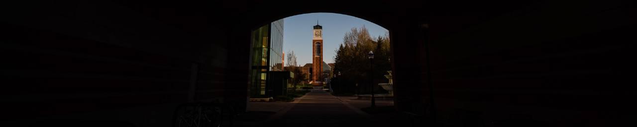 视图 of the clock tower through the arch of the  Arend & Nancy Lubbers Student Services Center.